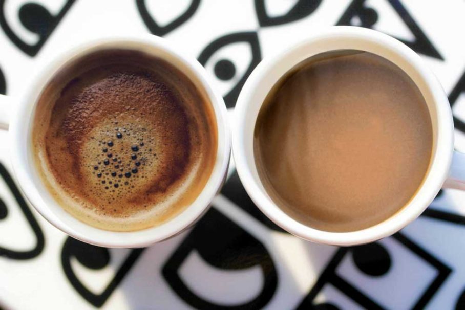 Cup of coffee beside a cup of kava